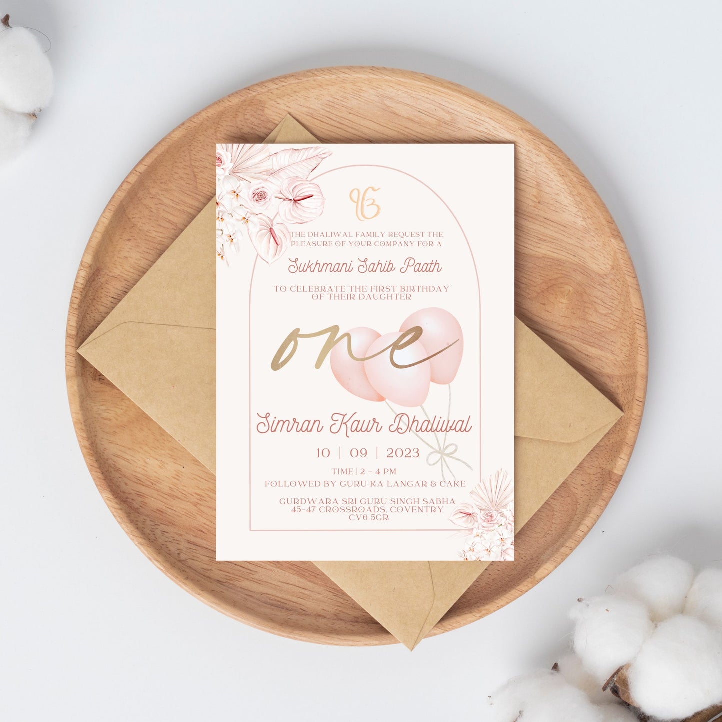 Elegant pink and gold floral themed portrait invitation to Sukhmani Sahib Paath for the birth/day of a daughter. Pink flowers in top left corner and bottom right with a pink arch which contains all the text for the date time and location of event