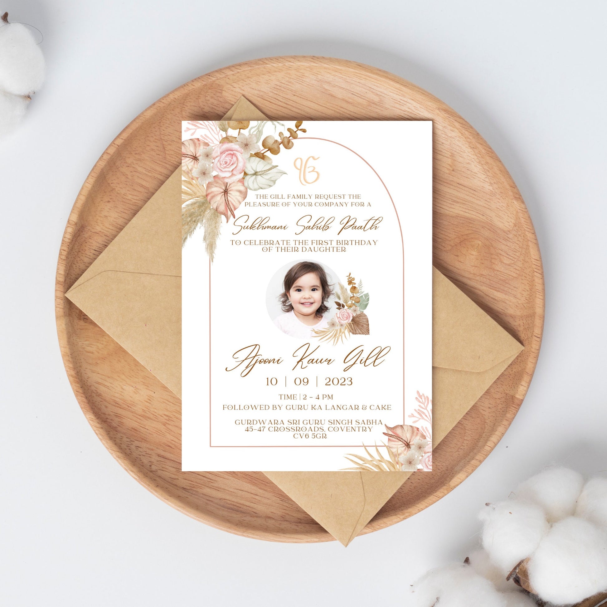 Elegant pink and beige floral themed photo invitation for Sukhmani Sahib Paath for the birth or birthday. Pink & beige flowers in top left corner and bottom right with a gold arch which contains all the text for the date time and location of event